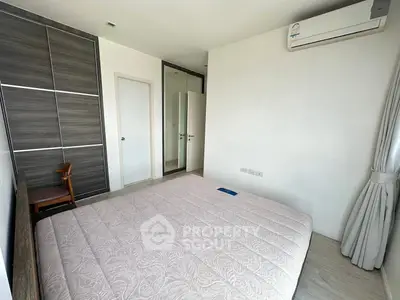Modern bedroom with large wardrobe and air conditioning unit
