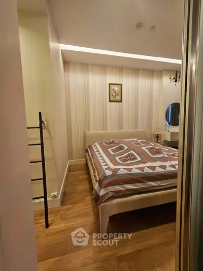 Cozy bedroom with elegant decor and wooden flooring, perfect for relaxation and comfort.