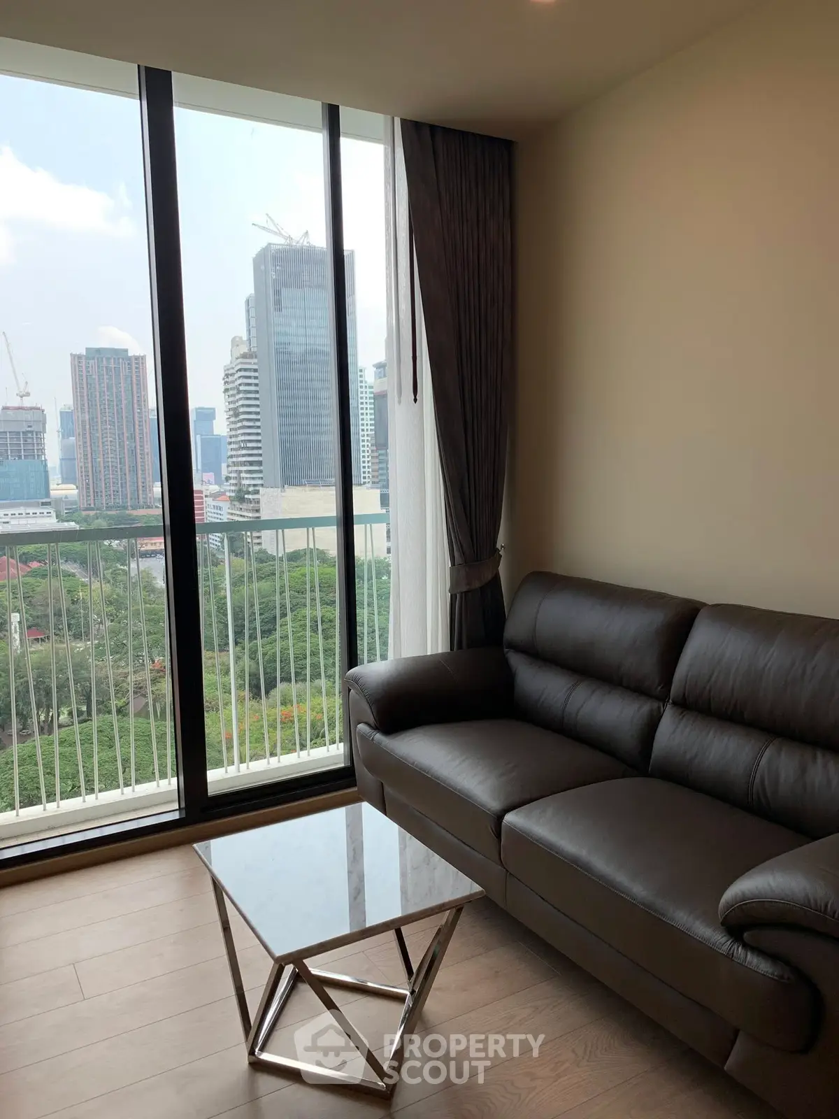 Modern living room with city view and stylish furniture in high-rise apartment.