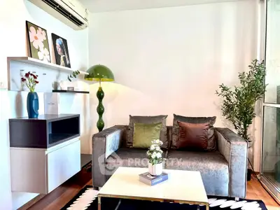 Stylish living room with modern decor, plush sofa, and vibrant accents in a cozy apartment.