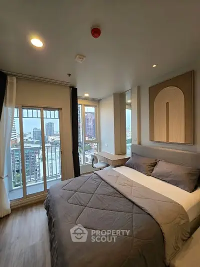 Modern bedroom with city view and stylish decor in high-rise apartment.