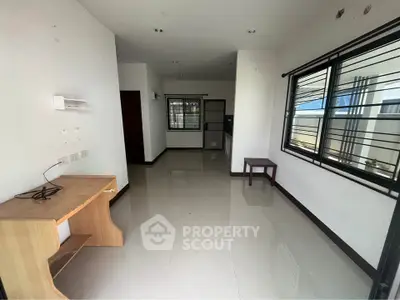 Spacious interior with glossy tiled floors and large windows, ideal for modern living.