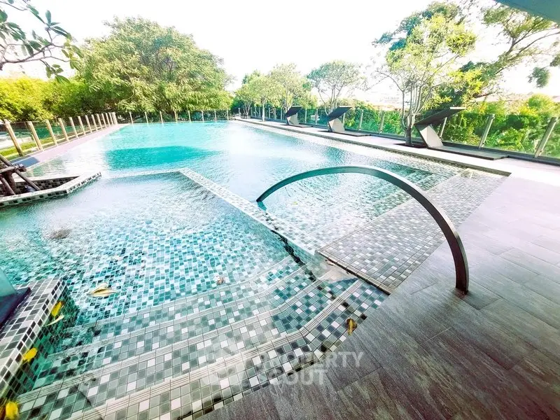 Luxurious outdoor pool with modern design and lush greenery, perfect for relaxation and leisure.