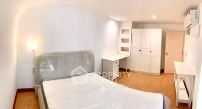 Spacious bedroom with modern furnishings and ample storage space