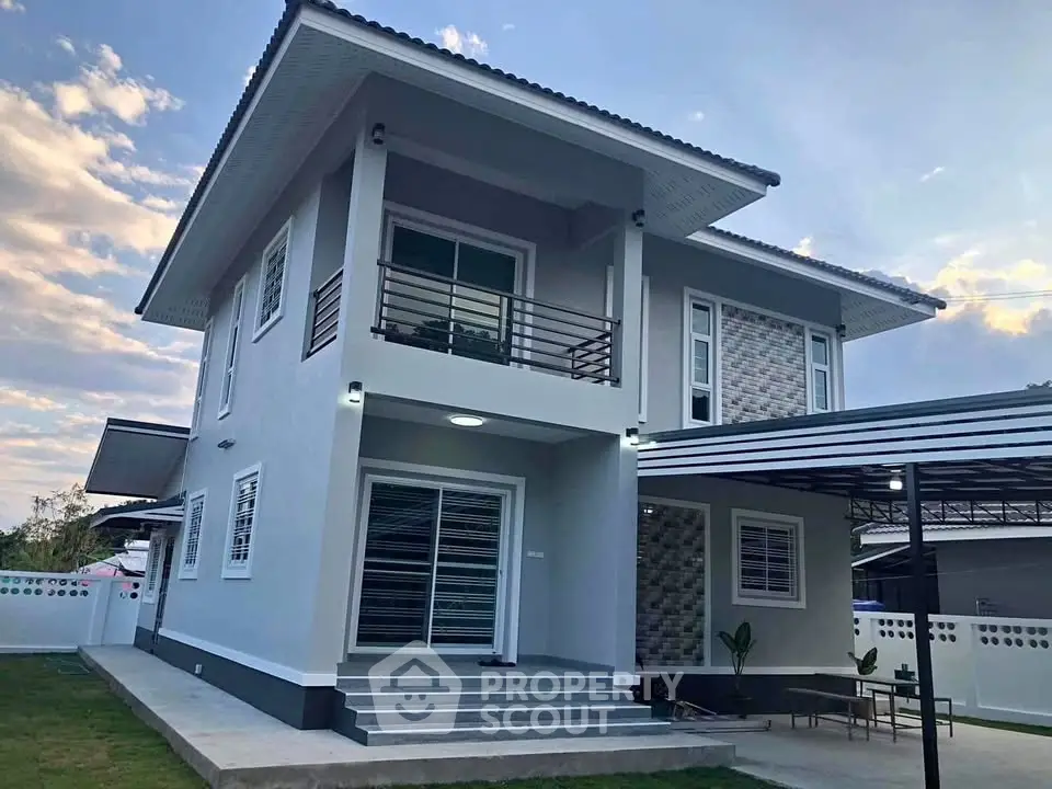 Modern two-story house with sleek design and spacious balcony, perfect for family living.