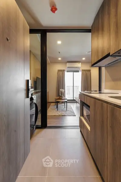 Modern apartment entrance leading to a stylish living room with balcony view.
