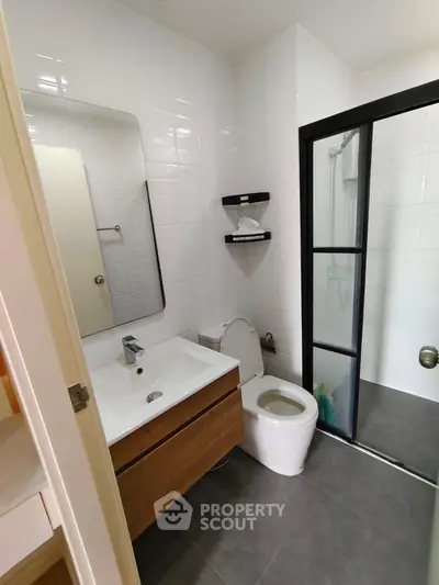 Modern bathroom with sleek fixtures and glass shower enclosure