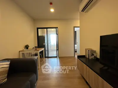 Modern living room with sleek furniture and open layout in a stylish apartment.