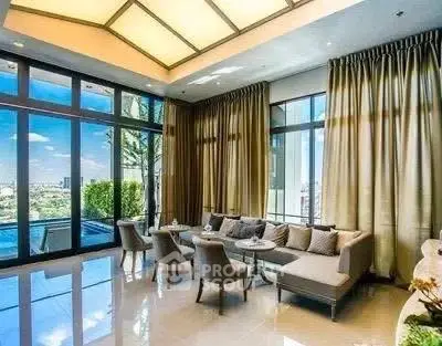 Luxurious living room with floor-to-ceiling windows and stunning outdoor view.