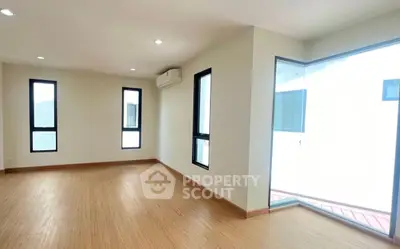Spacious corner unit with large windows and natural light in modern apartment.