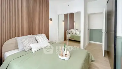 Modern bedroom with stylish decor and mirrored closet doors
