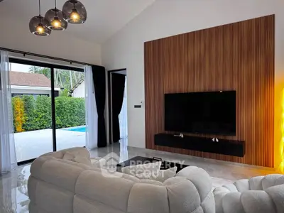 Luxurious living room with modern decor and pool view