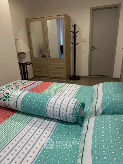 Cozy bedroom with colorful bedding and mirrored wardrobe