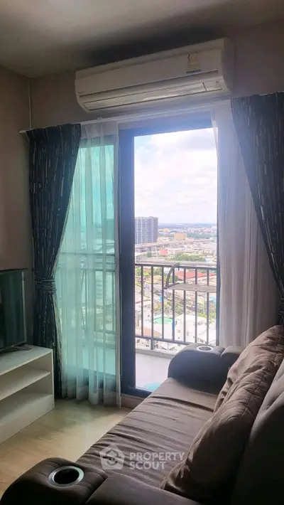 Cozy living room with balcony view and air conditioning in modern apartment
