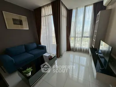 Modern living room with floor-to-ceiling windows and sleek furniture