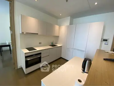 Modern kitchen with sleek cabinetry and built-in appliances in a contemporary apartment.