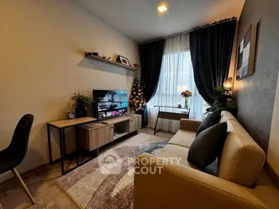 Cozy living room with modern decor, stylish furniture, and natural light from large window.