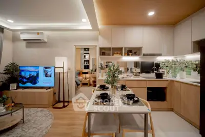 Modern open-layout living room and kitchen with stylish decor and dining area