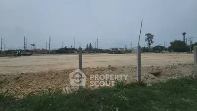 Expansive vacant land plot ideal for development with clear skies and surrounding infrastructure.