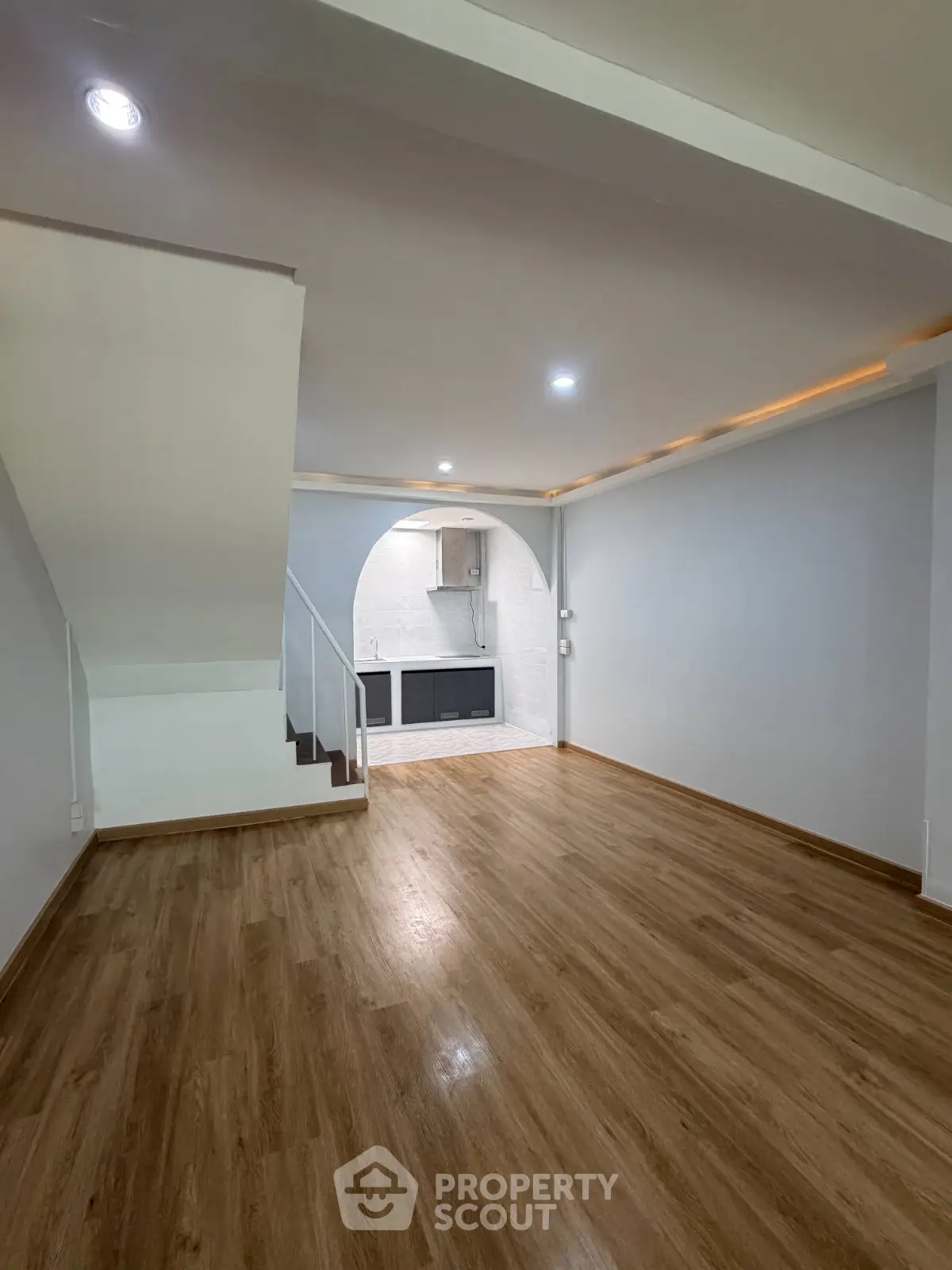 Spacious open-plan living area with modern kitchen and wooden flooring
