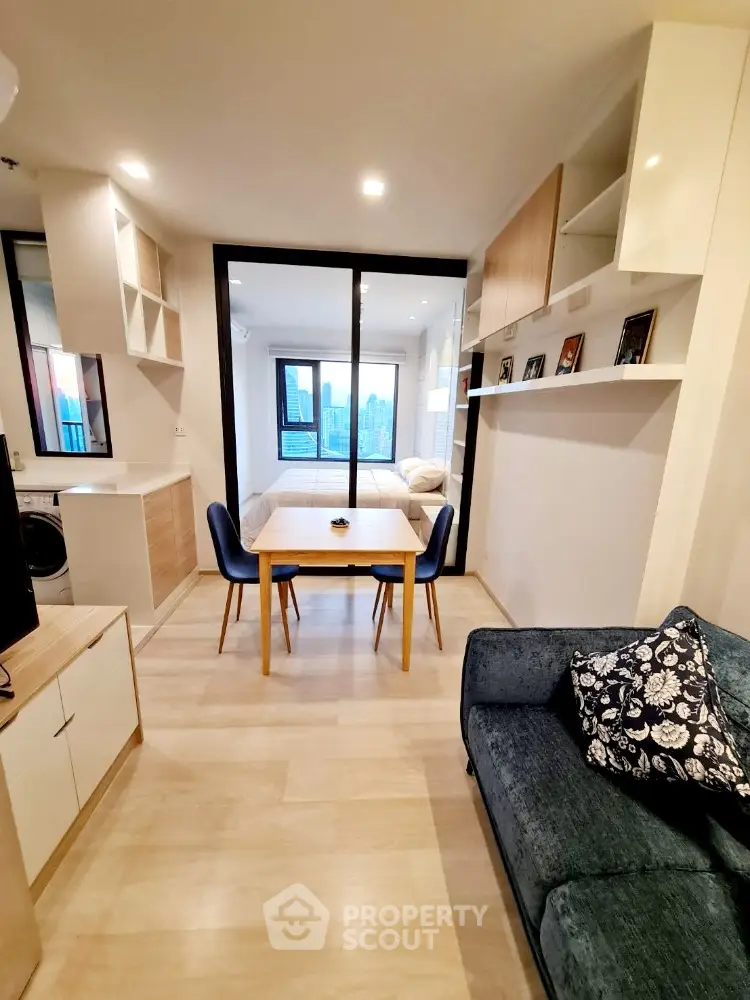 Modern open-plan living room with dining area and city view