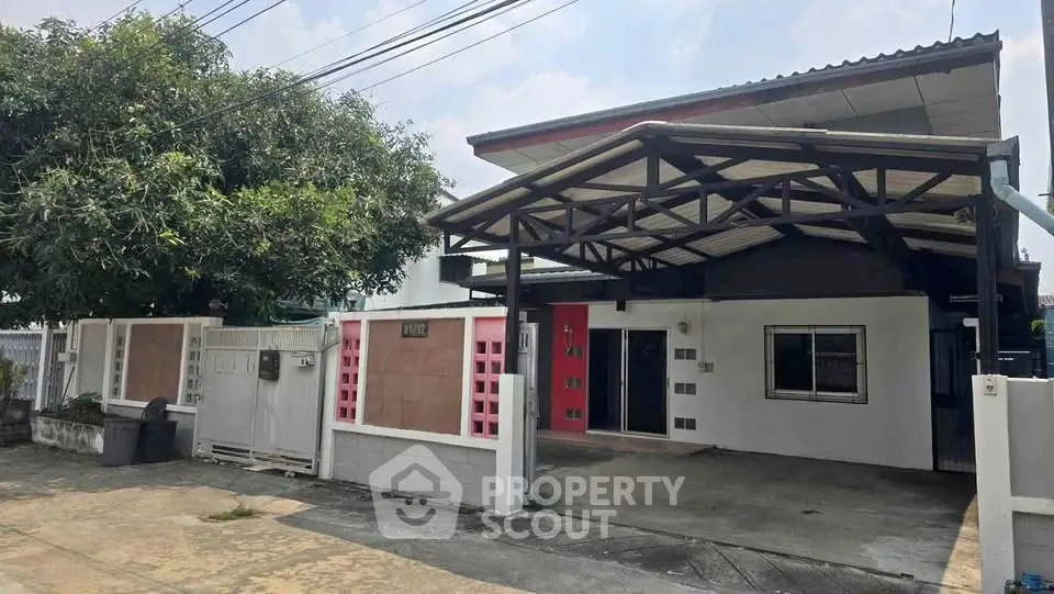 Charming single-story home with covered carport and spacious driveway in a quiet neighborhood.