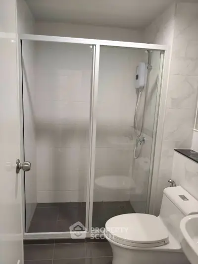 Modern bathroom with glass shower enclosure and sleek fixtures