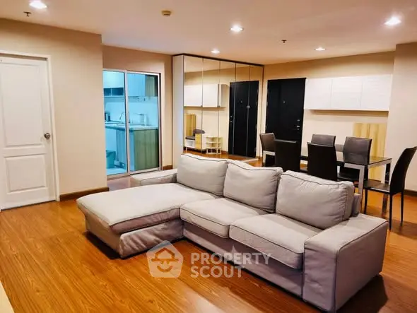 Spacious living room with modern furniture and open kitchen layout