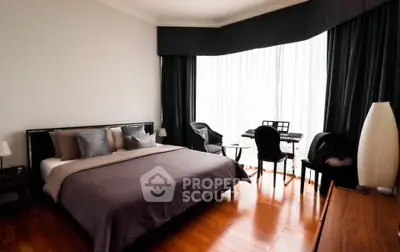 Spacious bedroom with elegant decor and natural light