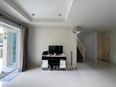 Spacious living room with modern decor and natural light