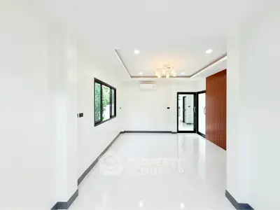 Spacious modern living room with elegant lighting and large windows