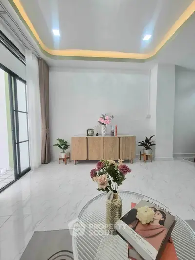Elegant living room with modern decor and natural light, featuring stylish furniture and a cozy ambiance.