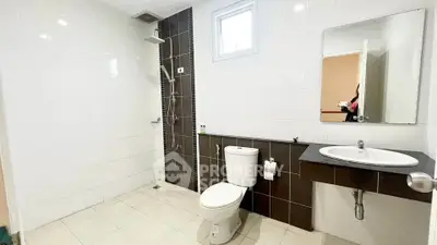 Spacious modern bathroom with sleek fixtures and elegant tile design.