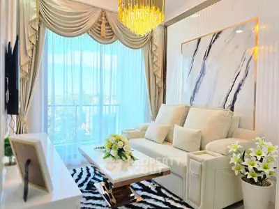 Luxurious living room with elegant decor, plush sofa, and stunning chandelier in a high-rise apartment.