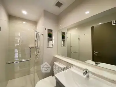 Modern bathroom with sleek fixtures and spacious shower area.