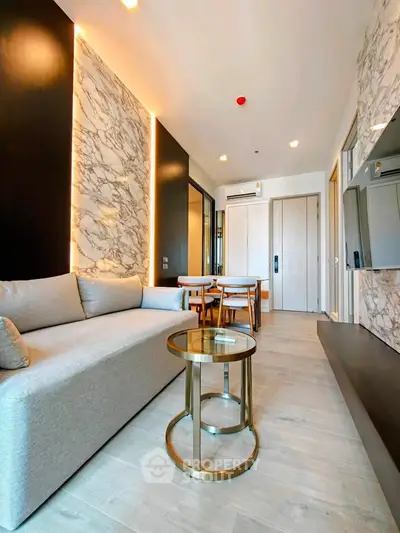 Modern living room with elegant marble accents and cozy seating area