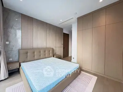 Spacious modern bedroom with stylish design and ample storage space