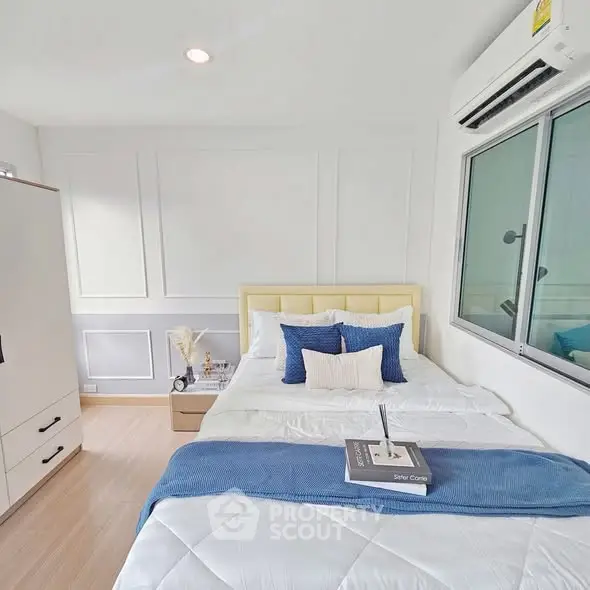 Bright and cozy bedroom with modern decor and air conditioning, perfect for relaxation.