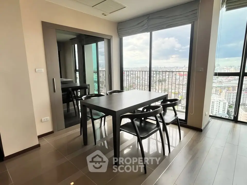Modern dining area with panoramic city view and sleek furniture