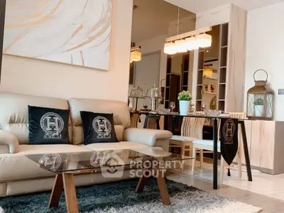 Modern living room with elegant decor and dining area, featuring plush seating and stylish lighting.