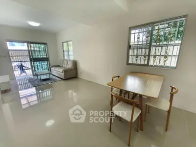 Spacious living and dining area with modern furniture and large windows