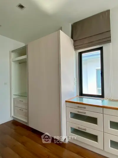 Spacious bedroom with built-in wardrobe and natural light