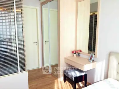 Chic bedroom with mirrored wardrobe and stylish vanity in modern apartment