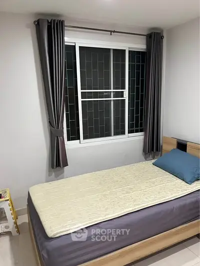 Cozy bedroom with single bed and modern window design