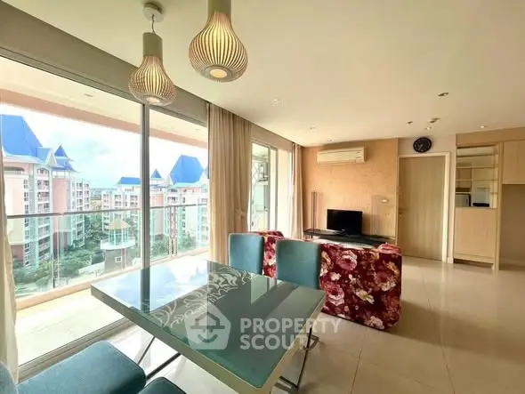 Spacious living room with modern decor and balcony view in luxury apartment.