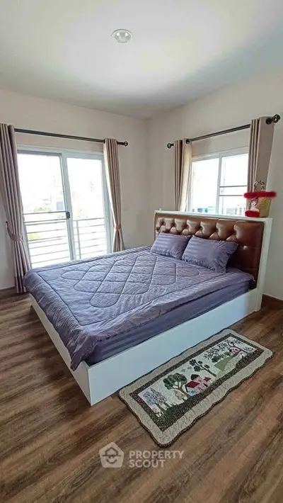 Spacious bedroom with large windows and stylish decor