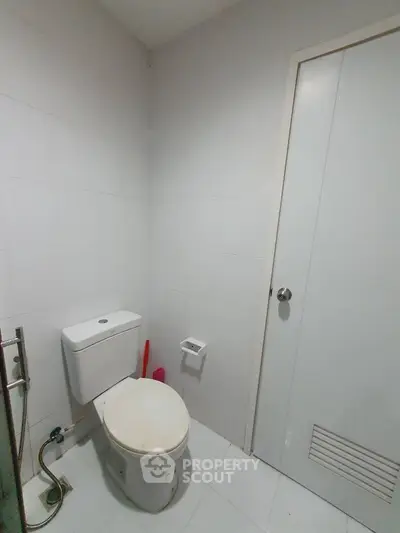 Minimalist bathroom with white tiles and modern toilet design