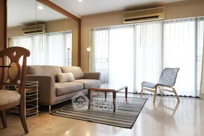 Spacious living room with modern furniture and large windows for natural light.