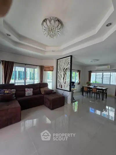 Spacious living room with elegant chandelier and modern decor