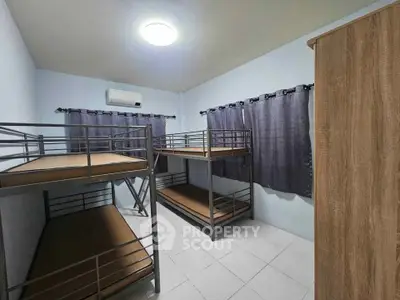Spacious bedroom with bunk beds and modern furnishings, ideal for shared living.